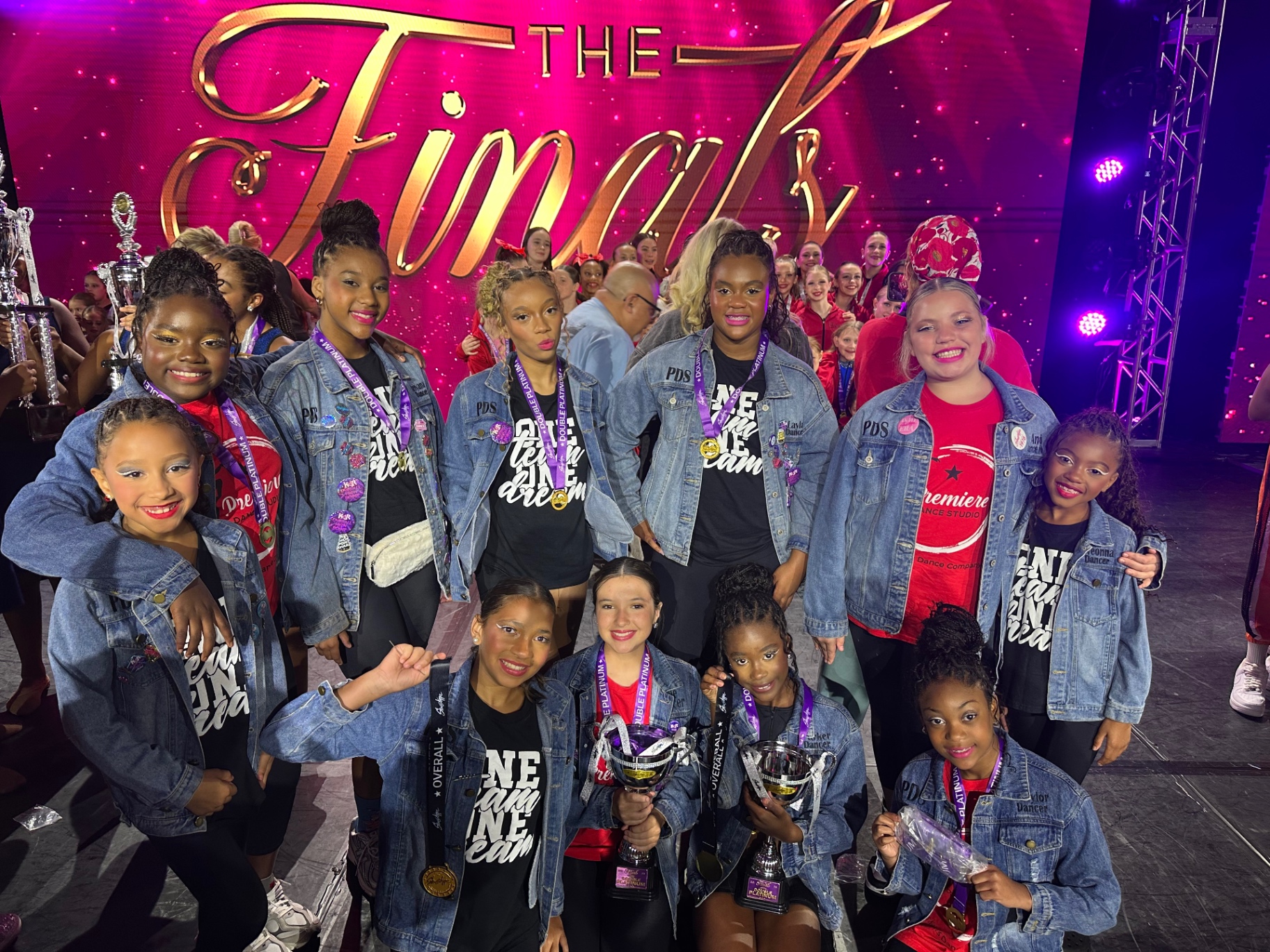 Premiere Dance Studio competition team celebrating at The Finals with trophies