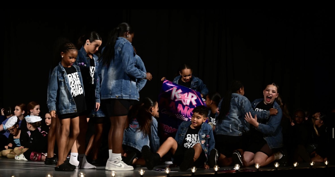 Premiere dancers on stage in denim team jackets