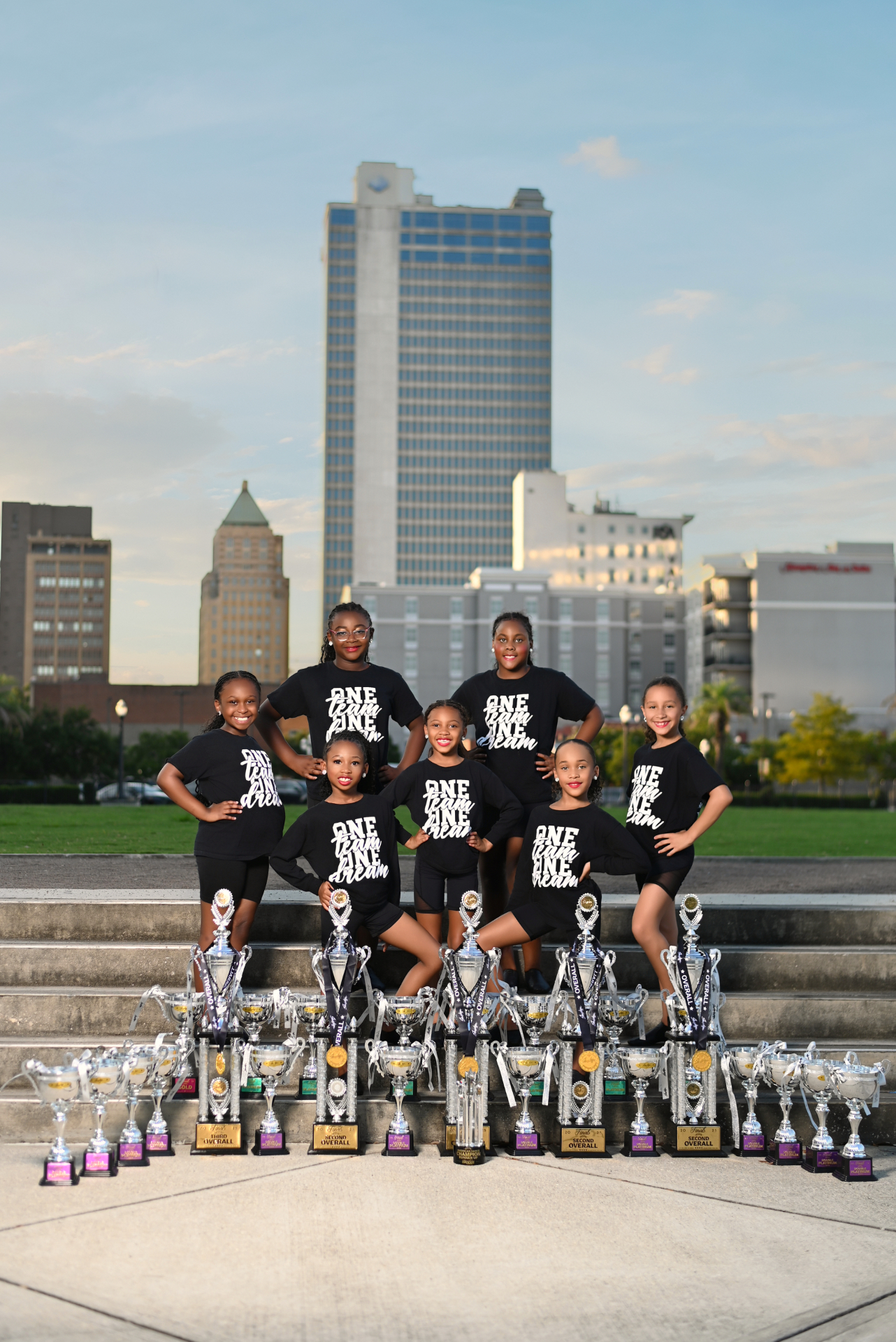 Premiere Dance Studio junior team posing proudly with their competition trophies